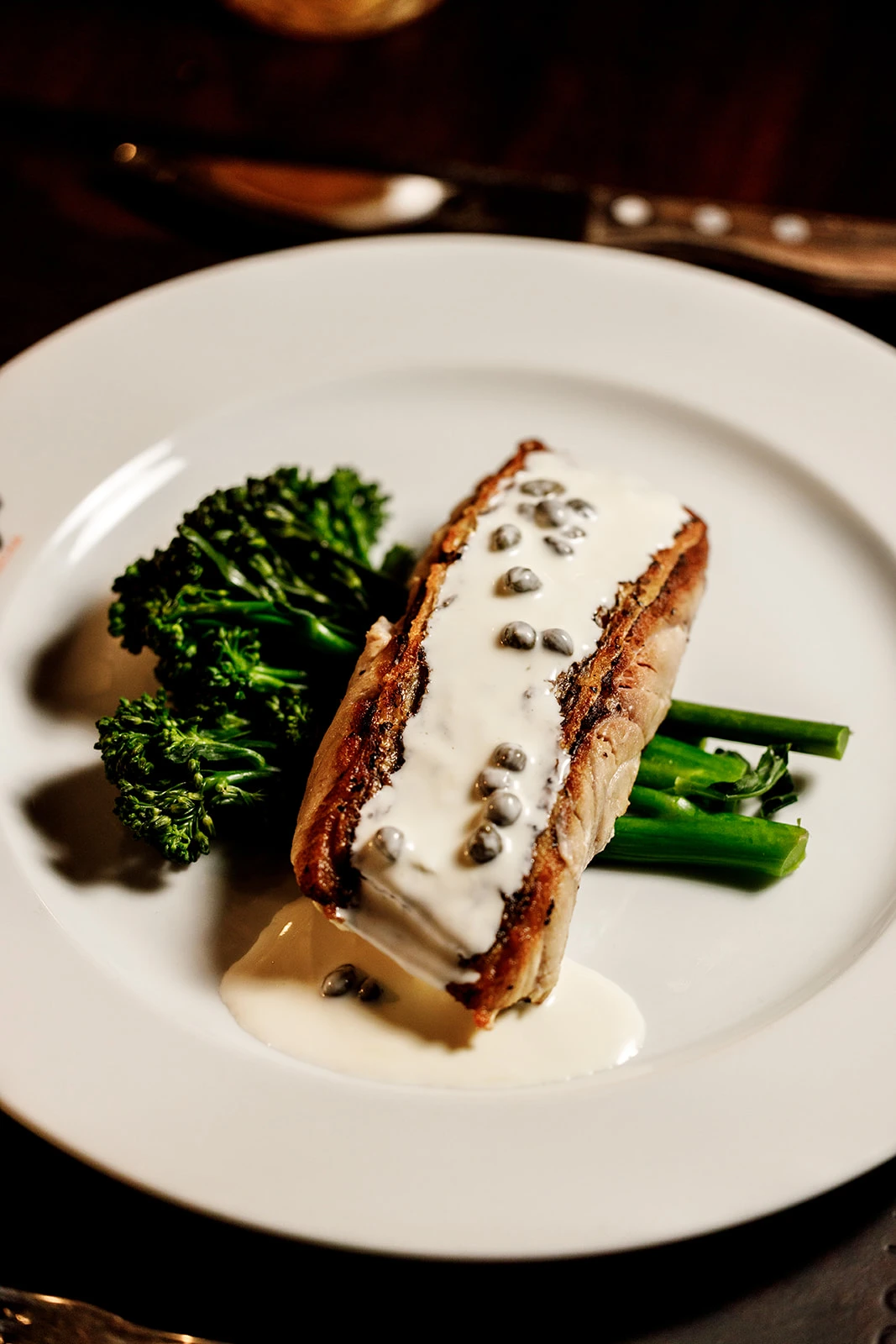 Pan-seared fish with a creamy caper sauce and broccolini