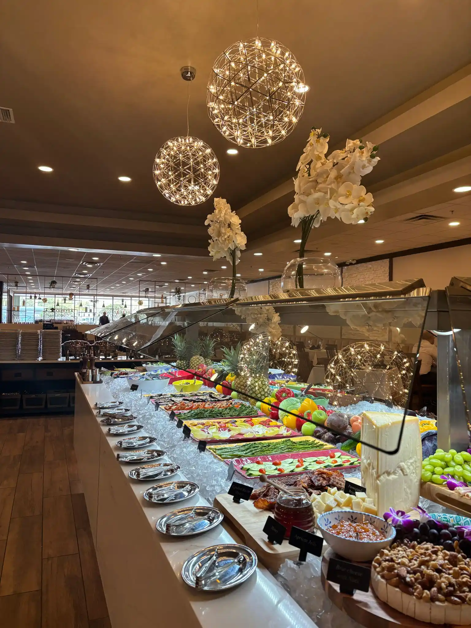The Gourmet Table at Adega Gaucha Deerfield Beach with charcuterie, cheeses, fruit and salads